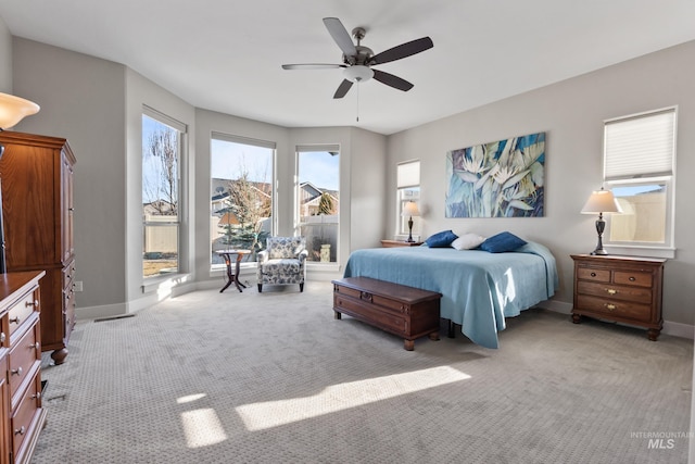 bedroom with baseboards, light carpet, and ceiling fan