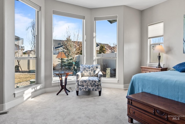 carpeted bedroom with visible vents and baseboards