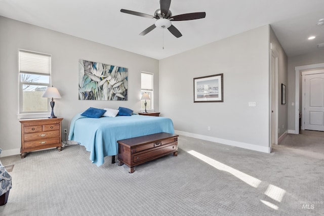 bedroom featuring multiple windows, baseboards, and carpet floors