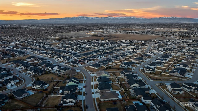 aerial view at dusk with a mountain view and a residential view