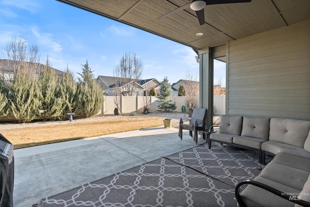 view of patio / terrace with an outdoor living space, a fenced backyard, and ceiling fan