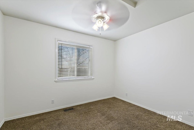 unfurnished room with visible vents, baseboards, carpet, and ceiling fan