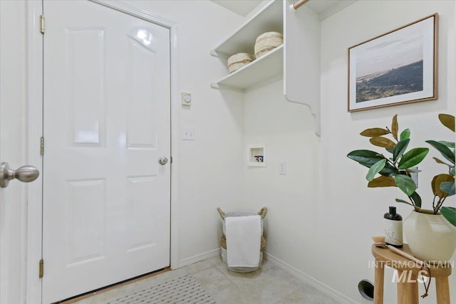 laundry area featuring laundry area, baseboards, and washer hookup