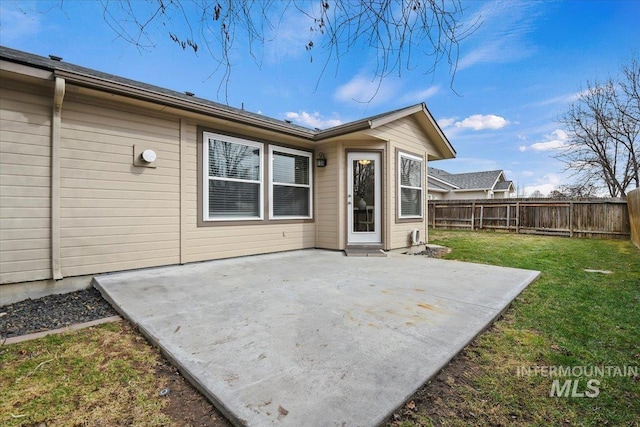 back of house with a patio, fence private yard, and a yard