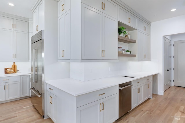 kitchen featuring light wood-style floors, stainless steel built in refrigerator, light countertops, and open shelves