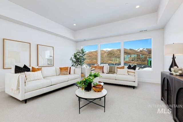 carpeted living room featuring recessed lighting, visible vents, and baseboards