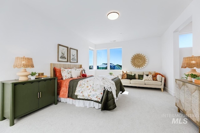 bedroom with light colored carpet and visible vents