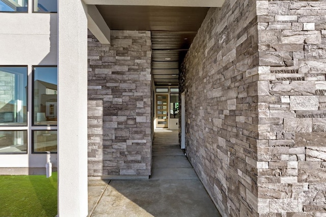 view of exterior entry featuring stone siding