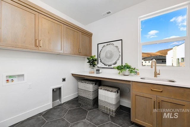 washroom with washer hookup, visible vents, cabinet space, hookup for an electric dryer, and a sink