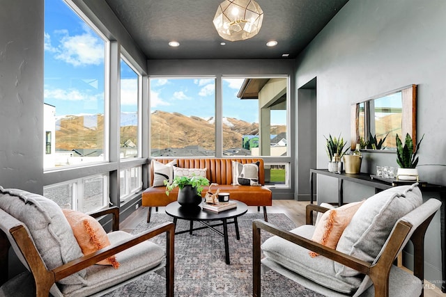 sunroom featuring a notable chandelier