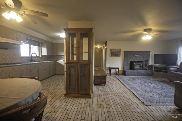 104 Friendship Ln, Council, ID 83612 - kitchen with ceiling fan, open floor plan, backsplash, and black cooktop