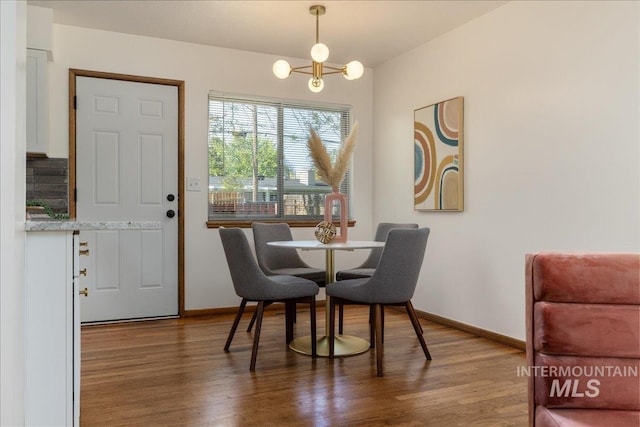 dining area featuring a notable chandelier and hardwood / wood-style flooring