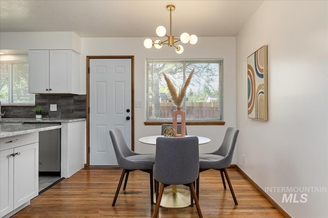 dining room featuring hardwood / wood-style flooring and an inviting chandelier