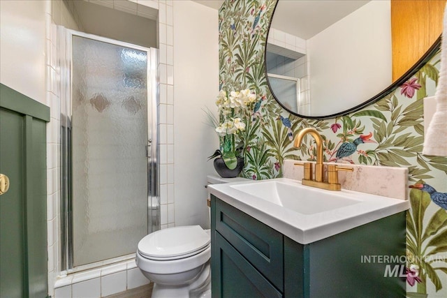 bathroom with vanity, toilet, and a shower with door