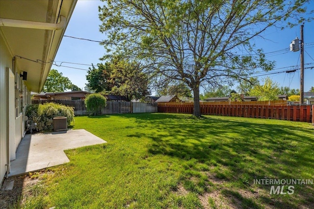 view of yard featuring central AC unit and a patio