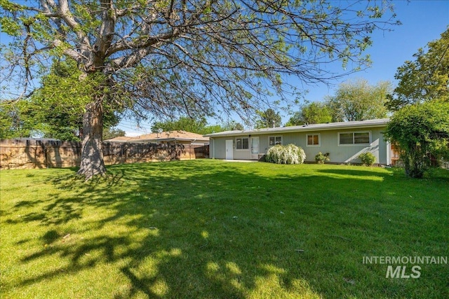 rear view of house with a lawn