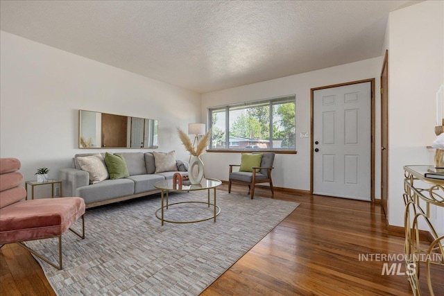 living room featuring hardwood / wood-style floors and a textured ceiling