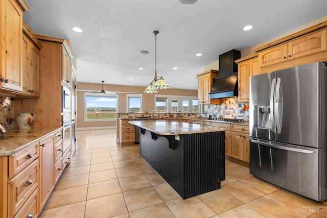 kitchen featuring appliances with stainless steel finishes, tasteful backsplash, light stone countertops, a peninsula, and recessed lighting