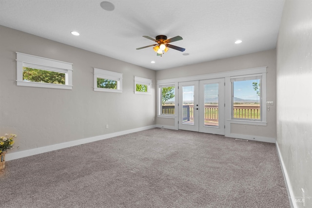 spare room with baseboards, french doors, and carpet