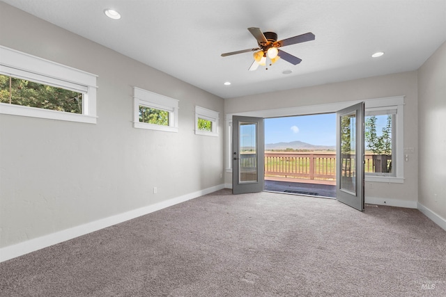 carpeted empty room featuring recessed lighting, baseboards, a ceiling fan, and a healthy amount of sunlight