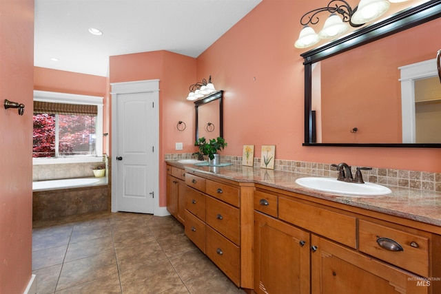 bathroom with double vanity, a sink, tile patterned flooring, and a garden tub