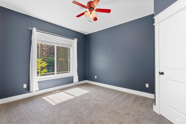 unfurnished room with carpet floors, ceiling fan, baseboards, and visible vents