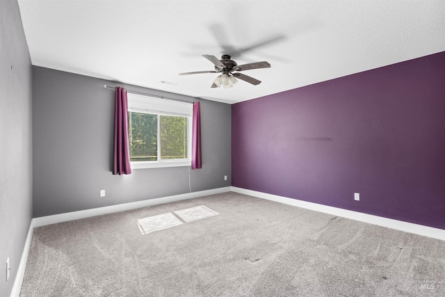 unfurnished room with baseboards, a ceiling fan, and carpet flooring