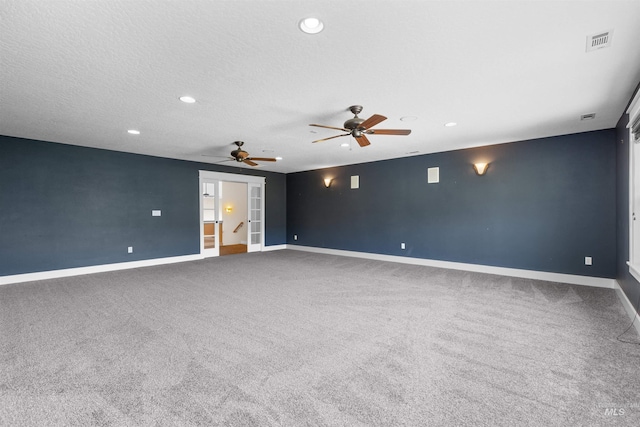 unfurnished room featuring carpet floors, baseboards, and visible vents