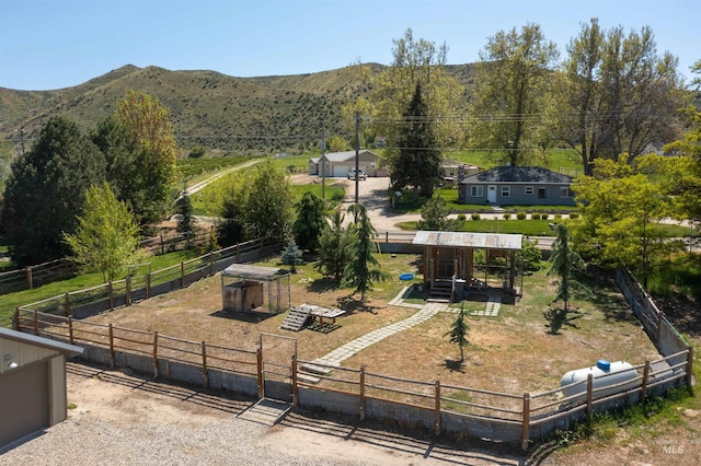 surrounding community with a playground, a mountain view, and a rural view