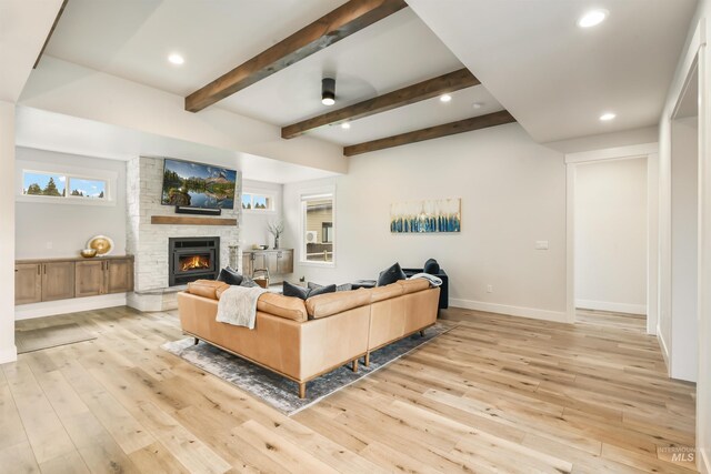 1112 Mos Way, Mccall, ID 83638 - living room featuring a stone fireplace, light wood-style floors, recessed lighting, baseboards, and beam ceiling