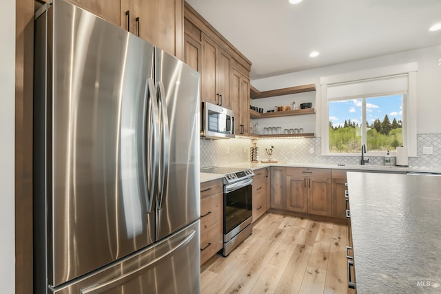 1112 Mos Way, Mccall, ID 83638 - kitchen featuring appliances with stainless steel finishes, light wood-style floors, open shelves, decorative backsplash, and recessed lighting