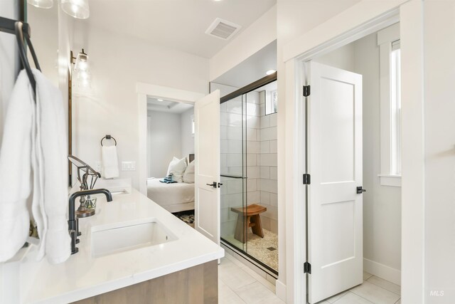 1112 Mos Way, Mccall, ID 83638 - full bathroom with ensuite bath, a stall shower, double vanity, tile patterned floors, and baseboards