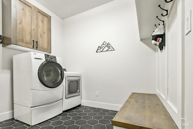 1112 Mos Way, Mccall, ID 83638 - laundry area featuring cabinet space, separate washer and dryer, baseboards, and dark tile patterned floors