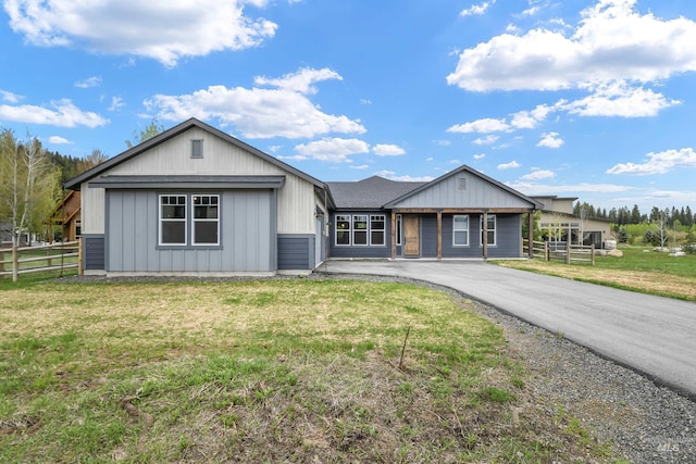 1112 Mos Way, Mccall, ID 83638 - view of front of home with asphalt driveway, board and batten siding, and an attached garage