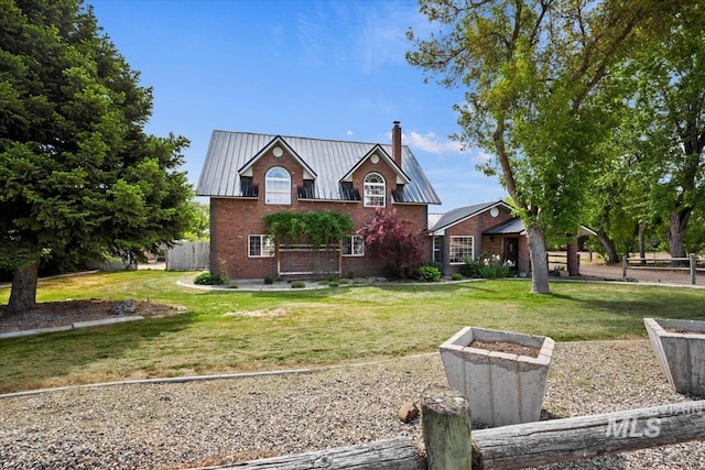 12091 Long St, Middleton, ID 83644 - traditional-style house with a chimney, a front yard, brick siding, and metal roof