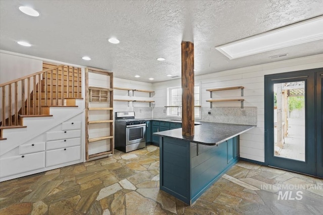 12091 Long St, Middleton, ID 83644 - kitchen with stainless steel range with gas cooktop, open shelves, a peninsula, blue cabinetry, and recessed lighting