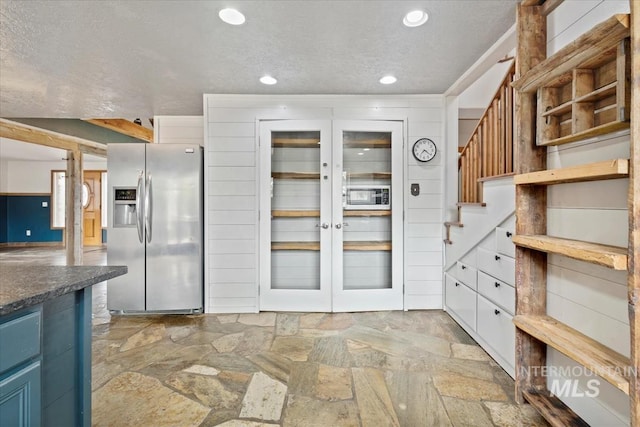 12091 Long St, Middleton, ID 83644 - kitchen featuring stainless steel fridge with ice dispenser, light stone finish floors, blue cabinets, recessed lighting, and a textured ceiling