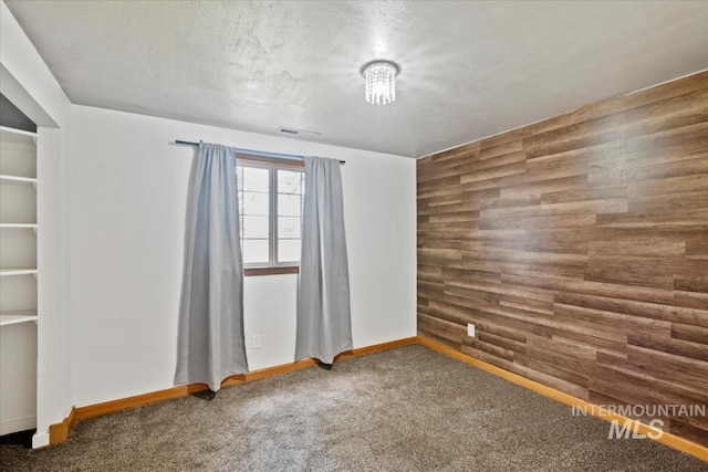 12091 Long St, Middleton, ID 83644 - spare room featuring carpet, wooden walls, and baseboards