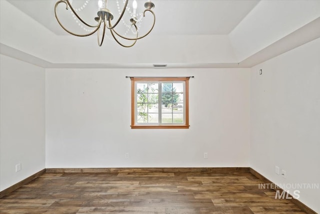 12091 Long St, Middleton, ID 83644 - unfurnished room with a tray ceiling, a chandelier, wood finished floors, and baseboards