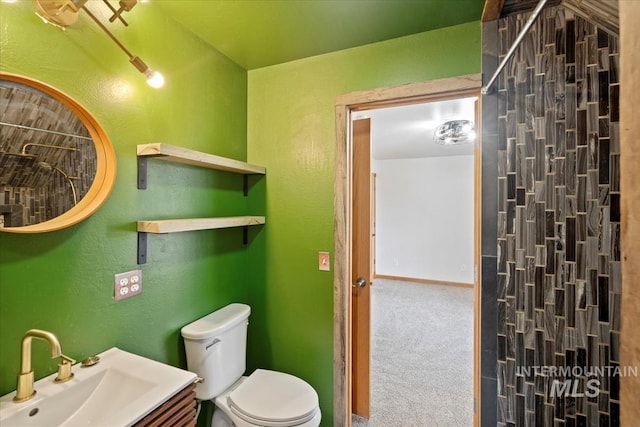 12091 Long St, Middleton, ID 83644 - bathroom featuring toilet, a textured wall, baseboards, and vanity