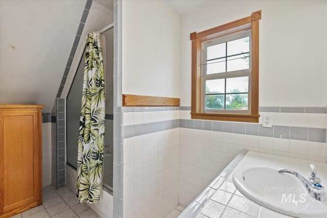 12091 Long St, Middleton, ID 83644 - bathroom featuring tile walls, tile patterned floors, a wainscoted wall, shower / bathtub combination with curtain, and a sink