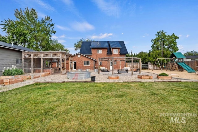 12091 Long St, Middleton, ID 83644 - rear view of property featuring a patio area, a playground, a hot tub, brick siding, and metal roof