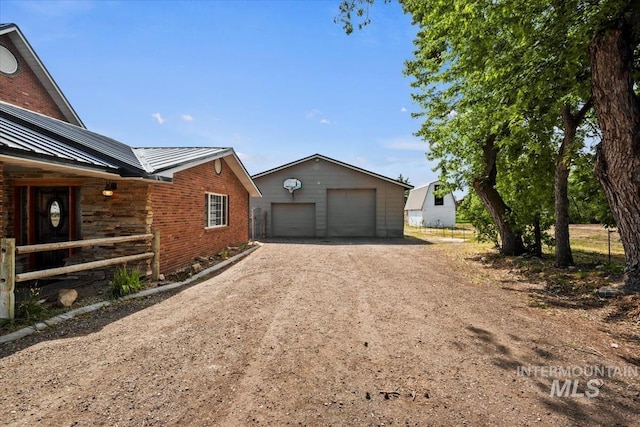 12091 Long St, Middleton, ID 83644 - view of side of property with a garage, an outbuilding, metal roof, brick siding, and a standing seam roof