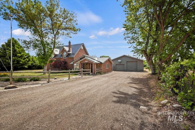 12091 Long St, Middleton, ID 83644 - view of front of property with a chimney, a garage, metal roof, and dirt driveway