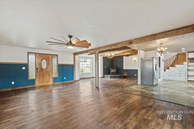 12091 Long St, Middleton, ID 83644 - unfurnished living room with a chandelier, wood finished floors, stairs, baseboards, and a textured ceiling