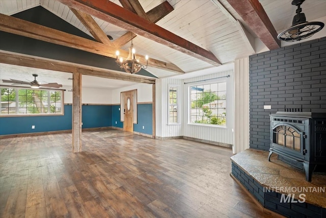 12091 Long St, Middleton, ID 83644 - living area featuring a wood stove, wood-type flooring, a chandelier, and baseboards
