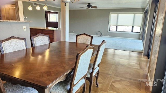 dining area with ornamental molding and a ceiling fan