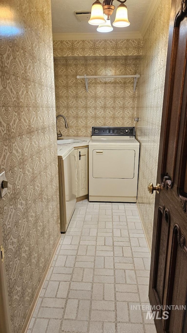 laundry area with wallpapered walls, cabinet space, crown molding, brick patterned floors, and baseboards