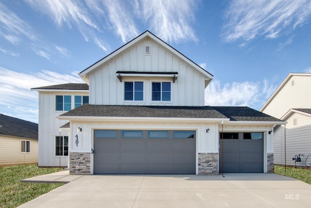 view of front of house featuring stone siding, board and batten siding, and driveway