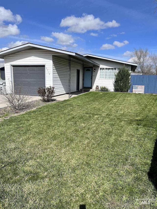 single story home with a front yard and a garage